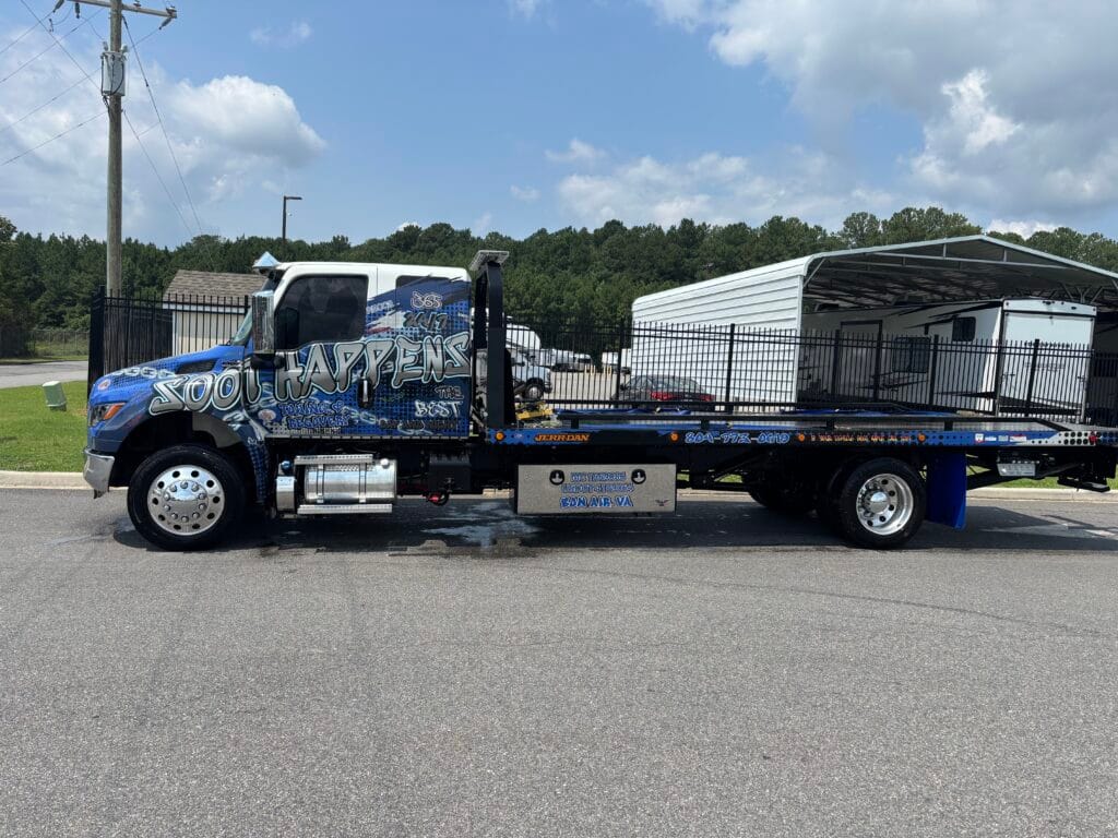 Soot Happens wrapped rollback tow truck