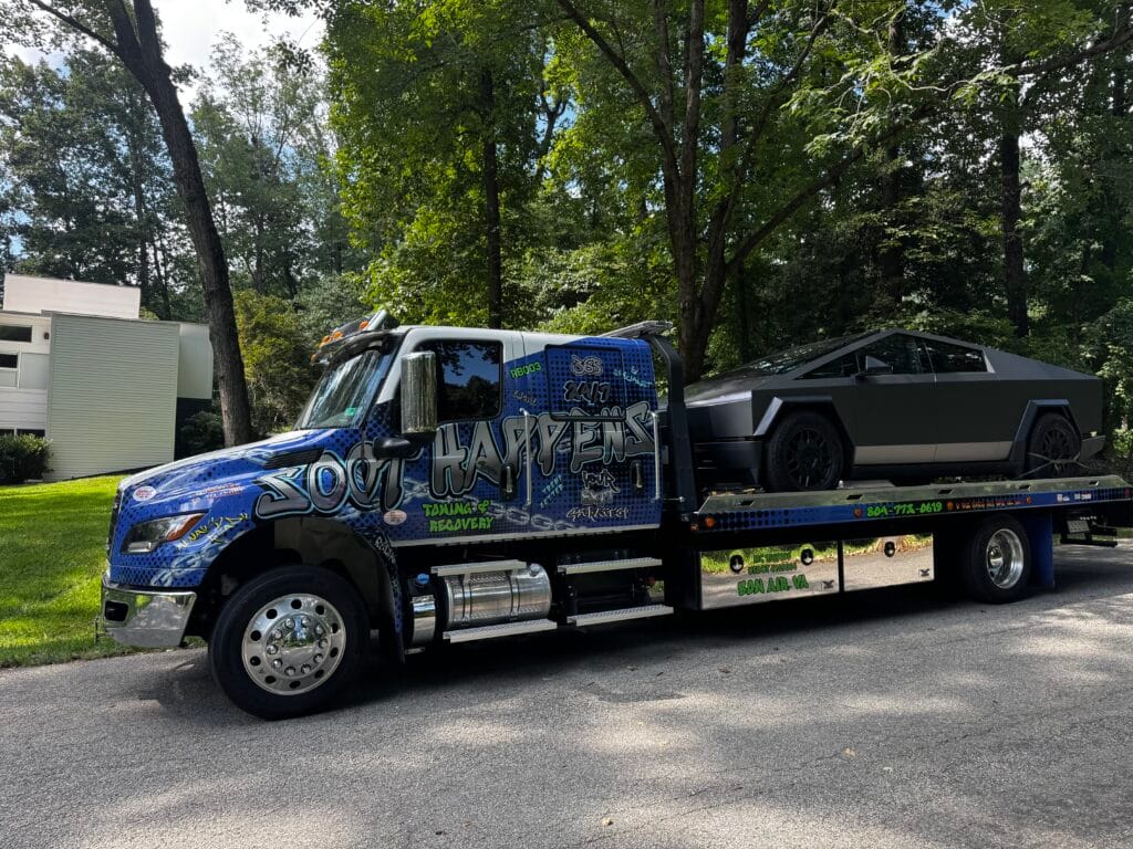Soot Happens rollback transporting an electric vehicle