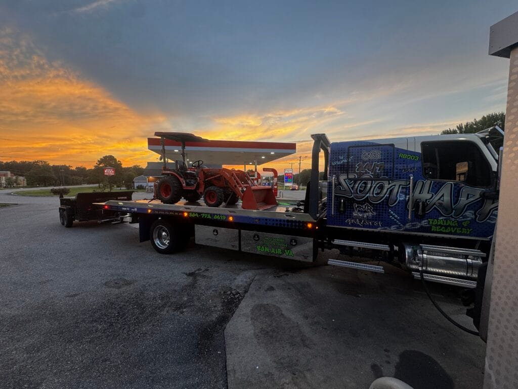 Soot Happens rollback transporting equipment at sunset